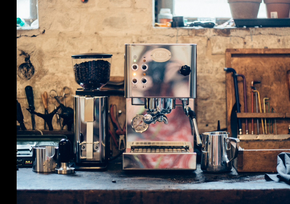 ecm casa v espresso machine with grinder and tamper in a kitchen